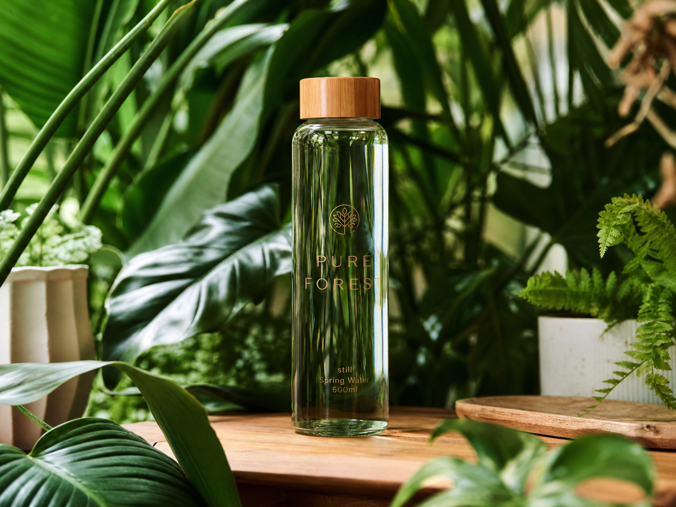 Starglass bottle surrounded by fresh green leaves